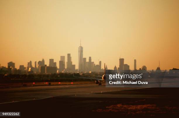nyc skyline view from airport with airplane taking off - new york skyline stock pictures, royalty-free photos & images