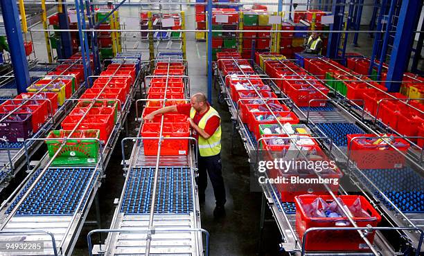 An employee arranges boxes of goods for delivery at an Ocado distribution center in Hatfield, U.K., on Monday, Sept. 21, 2009. Ocado Ltd., the U.K....