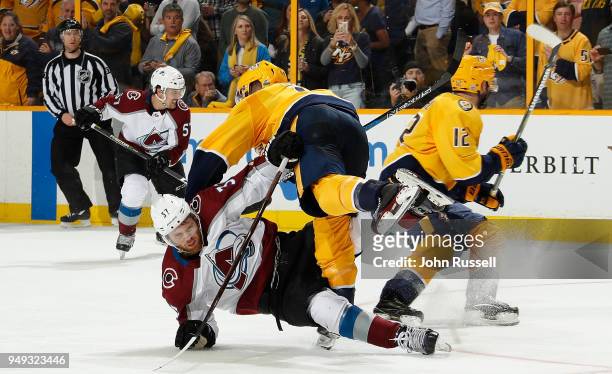 Ryan Ellis of the Nashville Predators delivers a hit on J.T. Compher of the Colorado Avalanche in Game Five of the Western Conference First Round...