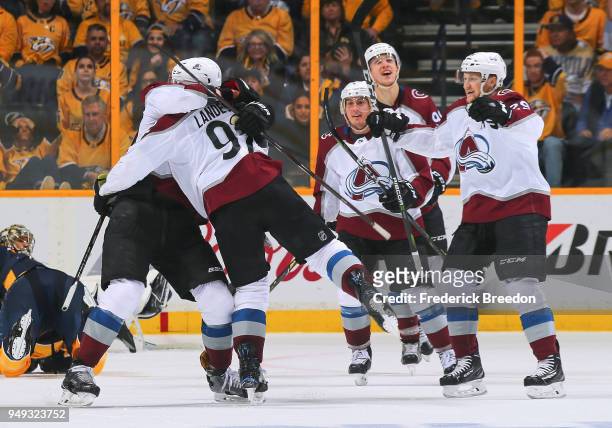 Gabriel Landeskog of the Colorado Avalanche is congratulated by teammates after scoring a goal against the Nashville Predators during the third...