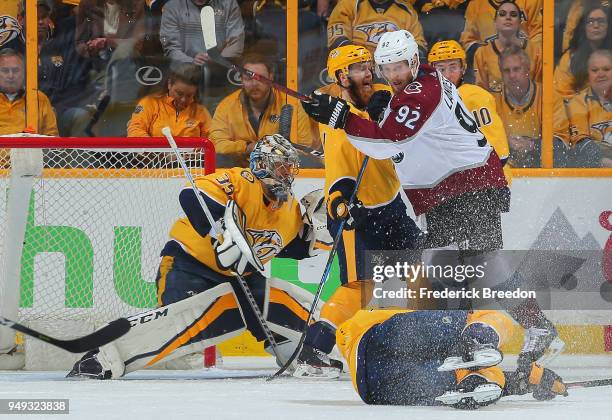 Gabriel Landeskog of the Colorado Avalanche pushes Ryan Ellis into goalie Pekka Rinne creating a scoring chance during the third period of a 2-1...