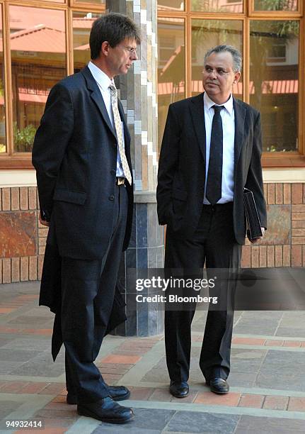 Jacob " Kobi'' Alexander, the former Comverse Technology Inc. Chief executive officer, right, talks with his lawyer, Louis du Pisani outside the...