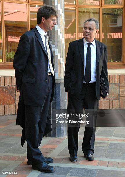 Jacob " Kobi'' Alexander, the former Comverse Technology Inc. Chief executive officer, right, talks with his lawyer, Louis du Pisani outside the...