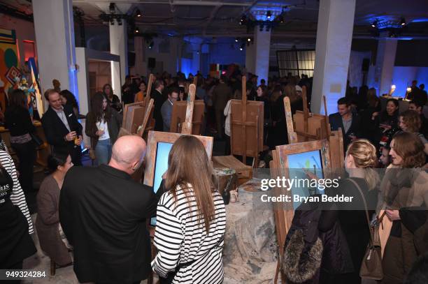 Guests interact with art during the National Geographic "Genius: Picasso" Tribeca Film Festival after party at The Genius Studio, 100 Avenue of the...