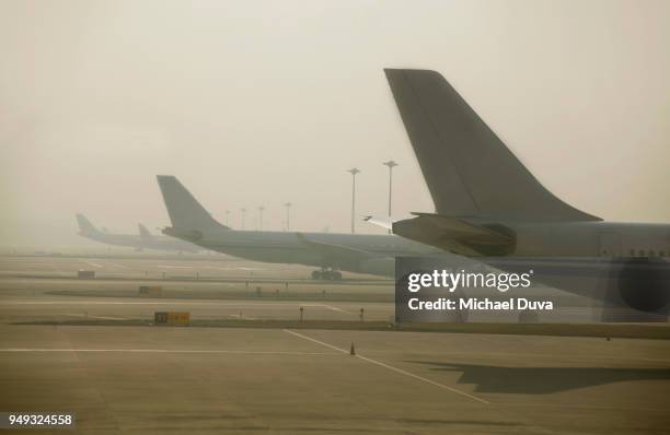 row of airplanes sitting at their gates - airplane pics stock pictures, royalty-free photos & images