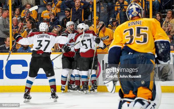 Sven Andrighetto celebrates his game winning goal with Gabriel Bourque and J.T. Compher of the Colorado Avalanche against Pekka Rinne of the...