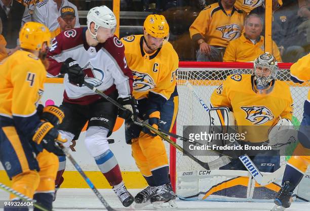 Carl Soderberg of the Colorado Avalanche and Roman Josi of the Nashville Predators skate in front of goalie Pekka Rinne during the third period of a...