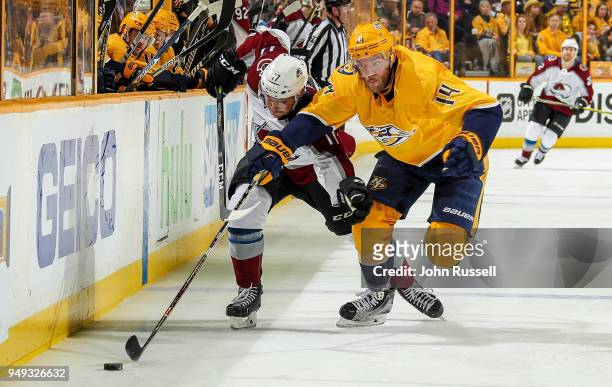 Mattias Ekholm of the Nashville Predators battles for the puck against Tyson Jost of the Colorado Avalanche in Game Five of the Western Conference...