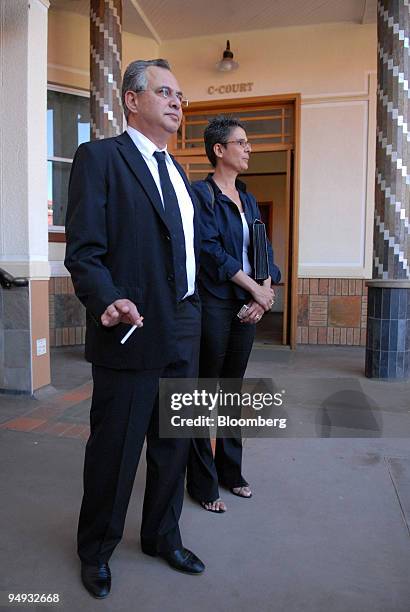 Jacob " Kobi'' Alexander, the former Comverse Technology Inc. Chief executive officer, left, accompanied by his wife Hana, stand outside the Windhoek...