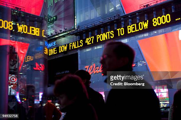 The Dow Jones ticker in Times Square displays news about the Dow closing below 8,000 at the end of the trading day in New York, U.S., on Wednesday,...
