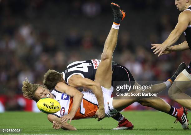 Lachie Whitfield of the Giants is tackled by Maverick Weller of the Saints during the round five AFL match between the St Kilda Saints and the...