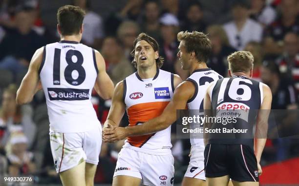 Ryan Griffen of the Giants is congratulated by his teammates after kicking a goal during the round five AFL match between the St Kilda Saints and the...