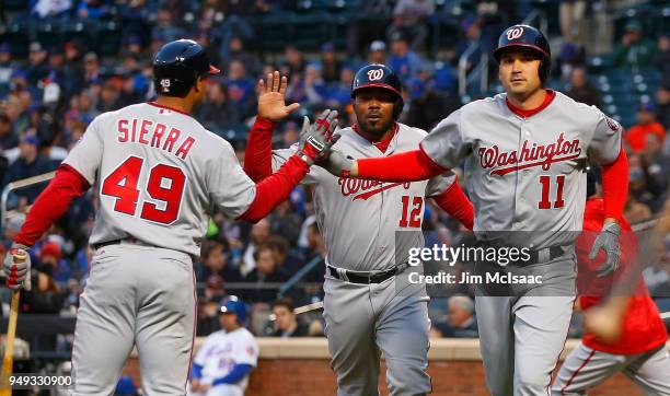 Ryan Zimmerman , Howie Kendrick and Moises Sierra of the Washington Nationals in action against the New York Mets at Citi Field on April 18, 2018 in...