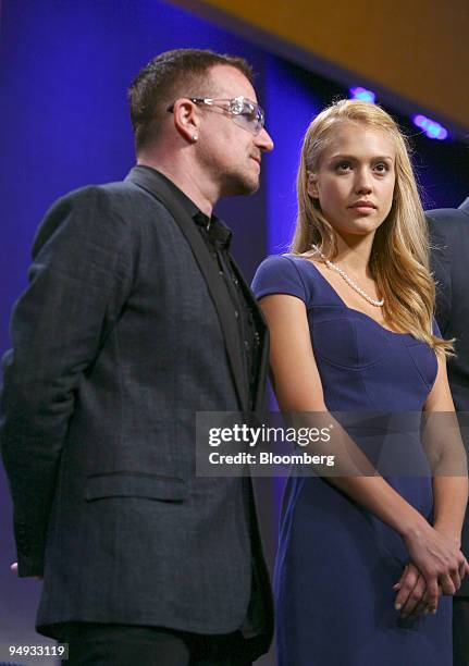 Bono, singer for the band U2, left, and actress Jessica Alba are introduced at the Clinton Global Initiative's annual meeting in New York, U.S., on...