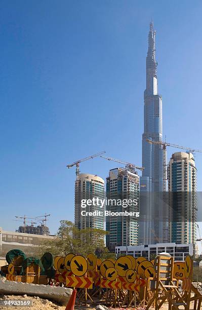 Cranes operate on construction sites near the Burj Dubai tower complex in Dubai, United Arab Emirates, on Sunday, Nov. 23, 2008. Dubai's focus on...