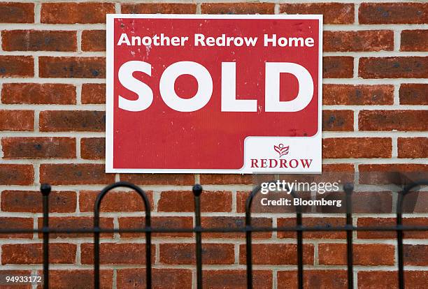 Sold' sign hangs on a recently completed property on a Redrow housing development in Bracknell, U.K., on Friday, Sept. 25, 2009. Barratt Developments...