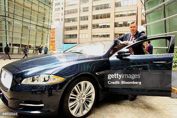 Michael O'Driscoll, managing director of Tata Motors Ltd.'s Jaguar brand, poses next to the new XJ model sedan in New York, U.S., on Wednesday, Sept....