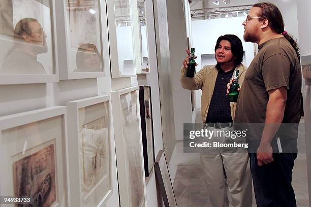 Bruno Boza, left, and Gunter Felix, students from the New World School of Arts, look at works on display at the Betty Cuningham Gallery New York...