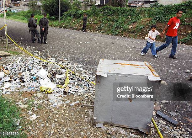 Broken safe lies outside the raided offices of a pyramid scheme in Mocoa, Colombia, on Dec. 2, 2008. More than three million Colombians may have lost...