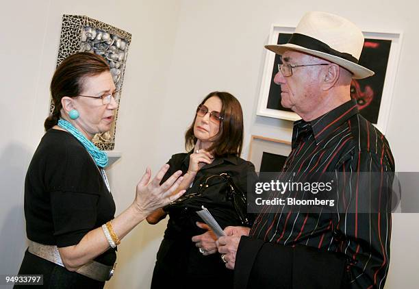 Art dealer Barbara Mathes, left, speaks to art collectors Ruth and Ted Baum of Palm Beach, Florida, in her booth during a preview for Art Basel Miami...