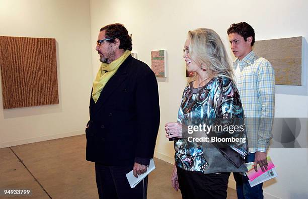 Artist and movie director Julian Schnabel, left, his son Vito right, and actress Faye Dunaway, look at works on display during a preview for Art...