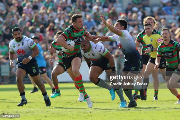 Sam Burgess of the Rabbitohs is tackled by the Raiders defence during the round seven NRL match between the South Sydney Rabbitohs and the Canberra...