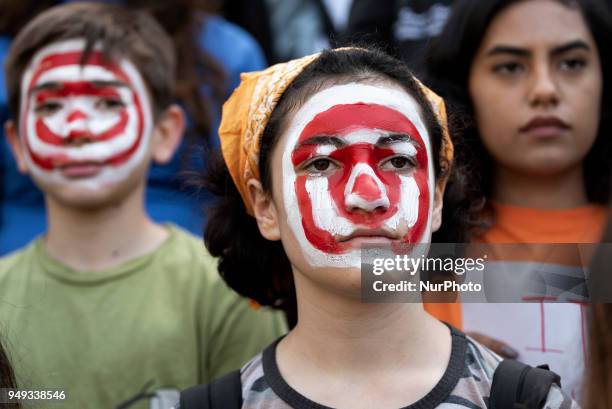Fourteen-year-old, Zoe Peters, with a target painted on her face participates in the National School Walkout in Los Angeles, California on April 20,...