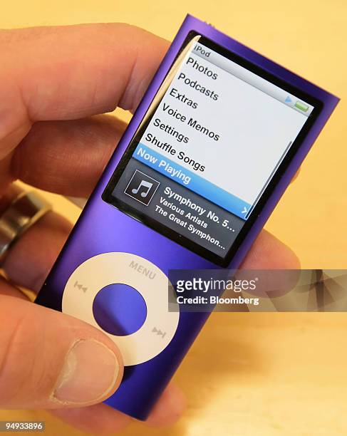 Customer looks at an Apple iPod Nano inside the Simply Mac Store in Orem, Utah, U.S., Jan. 21, 2009. Apple Inc. Reported an increase in first-quarter...