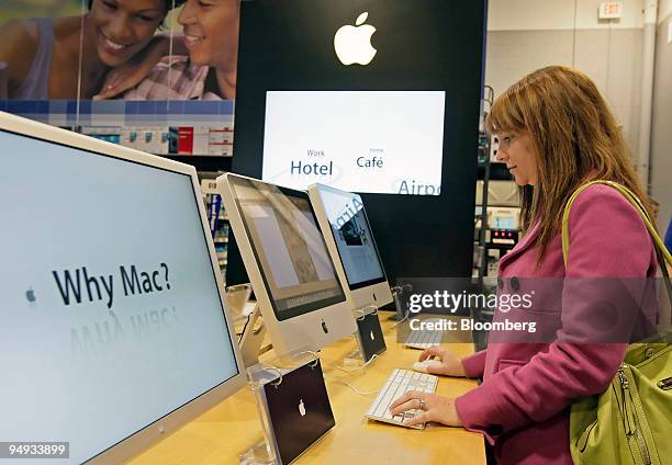 Amber Wahpcopp looks over an Apple iMac at a Best Buy store in Orem, Utah, U.S., Jan. 21, 2009. Apple Inc. Reported an increase in first-quarter...