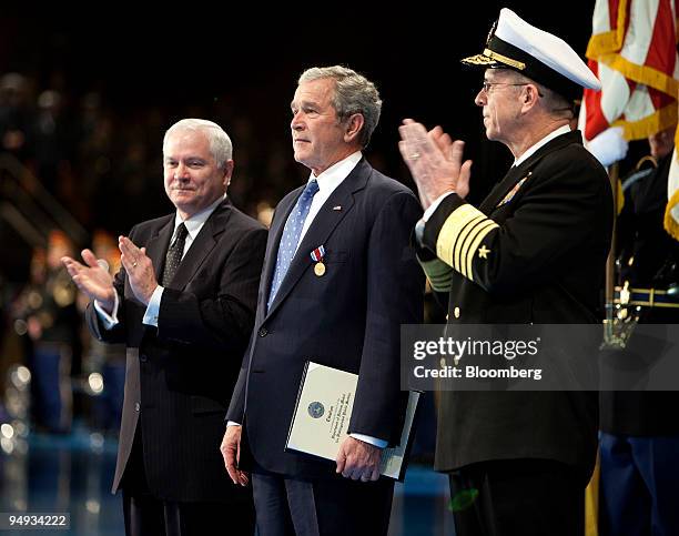 President George W. Bush, center, is applauded by Robert Gates, secretary of defense, left, and Admiral Michael Mullens, chairman of the Joint Chiefs...