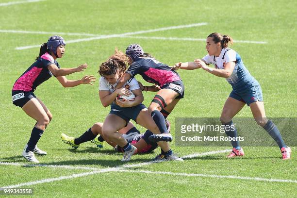 Chole Pelle of France is tackled on day one of the HSBC Women's Rugby Sevens Kitakyushu Pool match between France and Japan at Mikuni World Stadium...