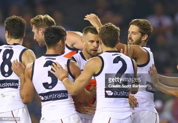 Brett Deledio of the Giants is congratulated by his teammates after kicking a goal during the round five AFL match between the St Kilda Saints and...