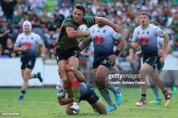 Sam Burgess of the Rabbitohs is tackled by the Raiders defence during the round seven NRL match between the South Sydney Rabbitohs and the Canberra...