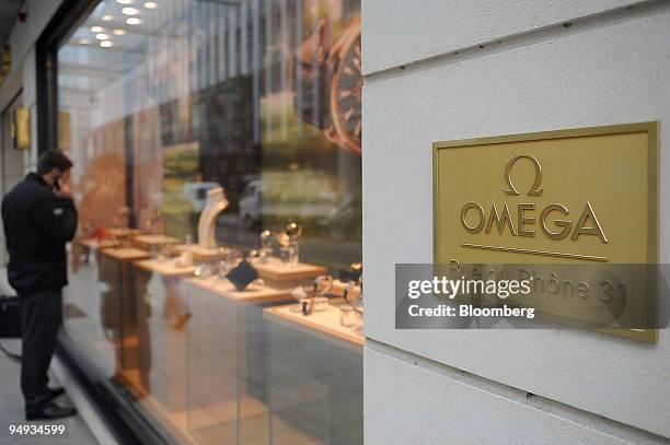 Man looks at an Omega store window display on Rue du Rhone in Geneva, Switzerland, on Friday, Jan. 30, 2009. The Madoff affair came on top of the...