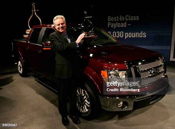 Derrick Kuzak, group vice president of product development with Ford Motor Co., holds up the Motor Trend 2009 Truck of the Year trophy they won for...