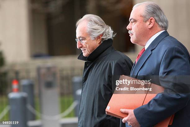 Bernard Madoff, founder of Bernard L. Madoff Investment Securities LLC, left, leaves federal court after a bail hearing in New York, U.S., on...