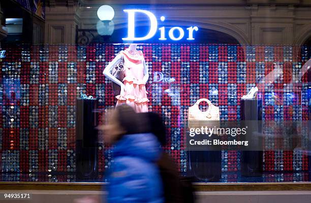 Shoppers walk past the Dior window display in the GUM department store in Moscow, Russia, on Thursday, Dec. 18, 2008. The ruble is poised for its...