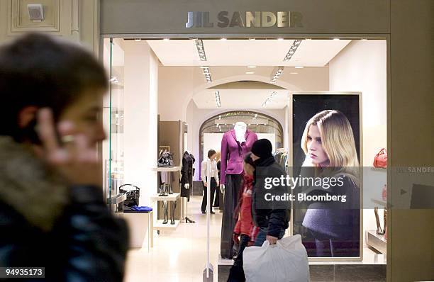 Shoppers walk past the Jill Sander boutique in the GUM department store in Moscow, Russia, on Thursday, Dec. 18, 2008. The ruble is poised for its...
