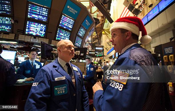 Traders Evan Solomon, left, and Stephen Nick work on the floor of the New York Stock Exchange leading up to the close on Christmas eve in New York,...