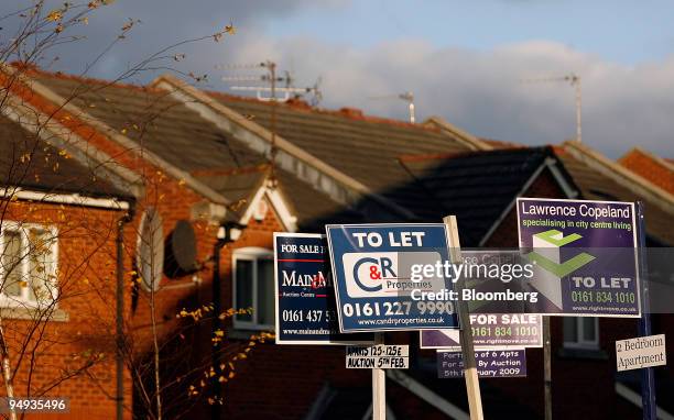 For Sale and To Let signs stand in front of residential properties in Manchester, U.K., on Monday, Dec. 29, 2008. U.K. House prices had the biggest...