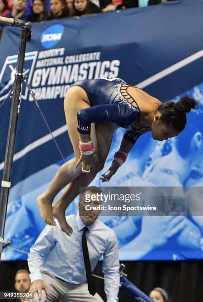 Assistant UCLA gymnastics coach Chris Waller watches as Anna Glenn of UCLA finishes her routine on the bars during the NCAA Women's Gymnastics...