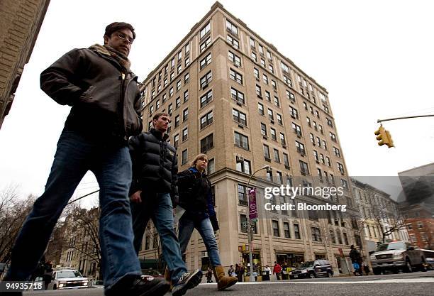 Pedestrians walk past the building that houses the apartment of Bernard Madoff, president and founder of Bernard L. Mandoff Investment Securities...