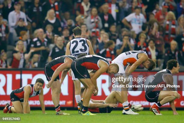 Dejected players slump over after scores are level at the final siren during the round five AFL match between the St Kilda Saints and the Greater...