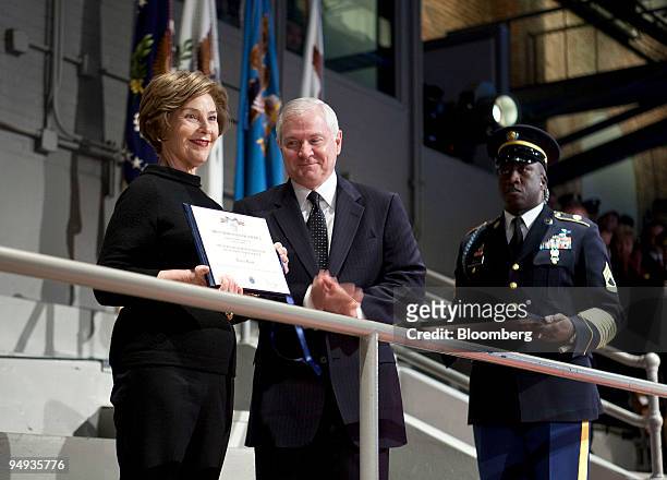 First lady Laura Bush receives the Secretary of Defense award for Outstanding Public Service from Robert Gates, U.S. Secretary of defense, during the...