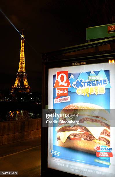 JCDecaux advertisement for the Belgian hamburger chain Quick hangs on the Champs-Elysees in Paris, France, on Wednesday, Jan. 22, 2009. The company...