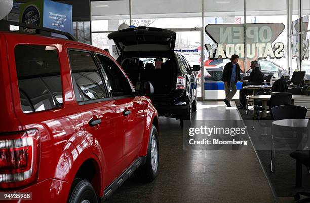 Woman talks to a salesman at the Royal Oak Ford dealership in Royal Oak, Michigan, U.S., on Saturday, Jan. 24, 2009. Ford, the only U.S. Automaker...