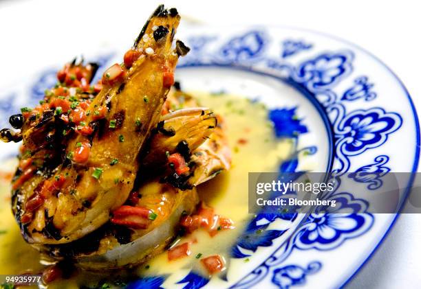 Serving of Portuguese style grilled prawns with vinho verde and garlic butter is arranged for a photo at Macao Trading Co., a Portuguese and Chinese...