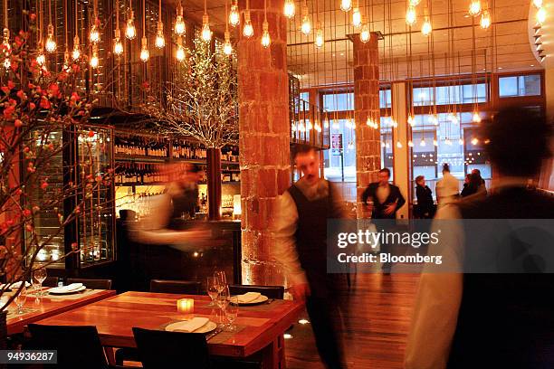 Waiters prepare the dining area at Craft, an American restaurant located at 43 East 19th Street in New York, U.S., on Saturday, Feb. 7, 2009....