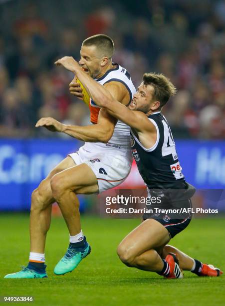 Brent Deledio of the Giants marks the ball in front of Maverick Weller of the Saints during the round five AFL match between the St Kilda Saints and...