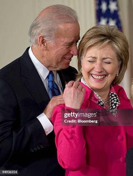 Vice President Joseh Biden, left, and Secretary of State Hillary Clinton share a laugh during a signing ceremony for the Lilly Ledbetter Fair Pay...